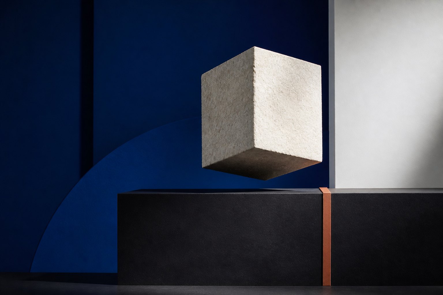 Abstract stone cube suspended over a dark geometric plane